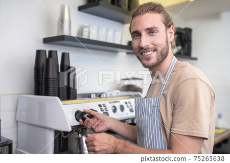 Busy happy man pouring water for coffee 75265638