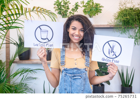 Smiling woman with lactose free gluten free posters 75265731