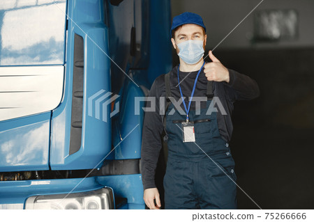 Worker checks product in mask during coronavirus 75266666