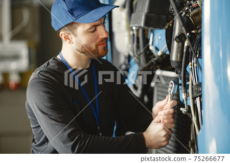 ar mechanic repairs blue car in garage with tools 75266677