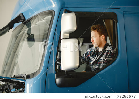 Driver of blue truck and a shirt in a cell brought goods 75266678