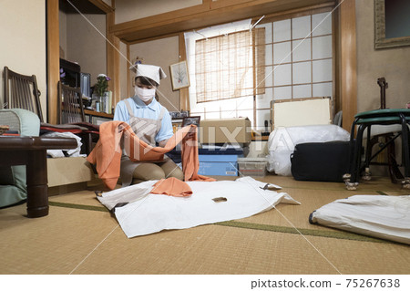 Female worker cleaning up a messy room 75267638