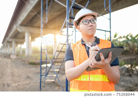 Asian worker using digital tablet at construction site Asian worker using digital tablet at construction site 75268044