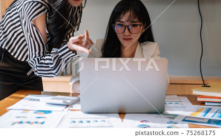 Business professionals. Group of young confident business people analyzing data using computer in the office. Business professionals. Group of young confident business people analyzing data using computer in the office. 75268175