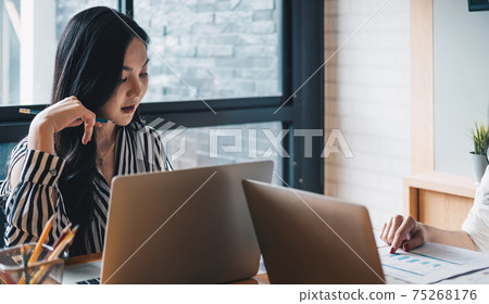 Young business teamwork using laptop with business report document and Brainstorming Planning Partnership Young business teamwork using laptop with business report document and Brainstorming Planning Partnership 75268176