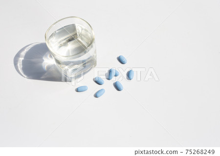 PrEP ( Pre-Exposure Prophylaxis) used to prevent HIV with glass of water 75268249