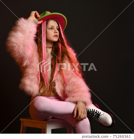 Teenager girl posing in studio wit a chair and a Teenager girl posing in studio wit a chair and a 75268361