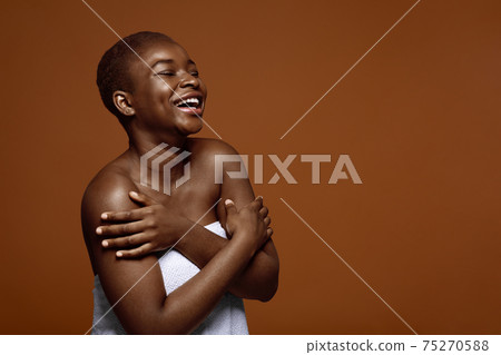 Chherful Beautiful Black Lady Standing With Folded Arms Wrapped In Towel Chherful Beautiful Black Lady Standing With Folded Arms Wrapped In Towel 75270588