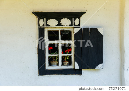 Old wooden window with shutter in old traditional ukrainian clay house 75271071