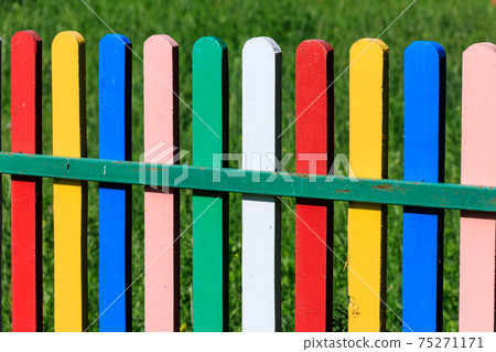 Close-up of the multicolored painted wooden fence Close-up of the multicolored painted wooden fence 75271171