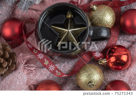 Red and golden christmas figures in the cup and around it Red and golden christmas figures in the cup and around it 75271343