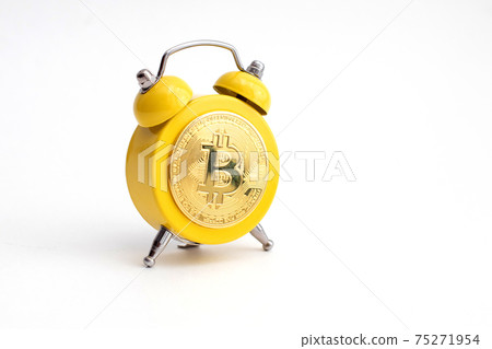 Yellow Alarm clock shows bitcoin on display. Good time to earn and mining a crypto currency 75271954