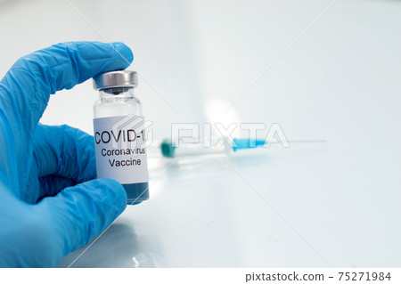 Doctor holding tube with Coronavirus vaccine for 2019-nCoV virus. Novel Coronavirus 2019-nCoV in vial. 75271984