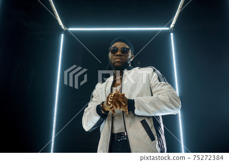 Stylish rapper in sunglasses, dark background 75272384