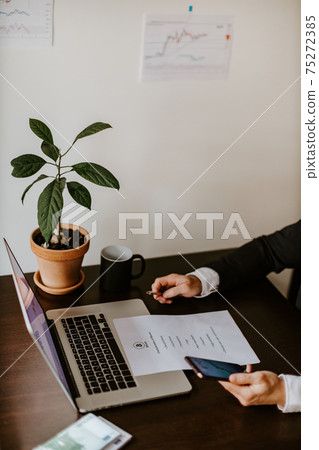 stock trader price trend graph analysing on laptop 75272385