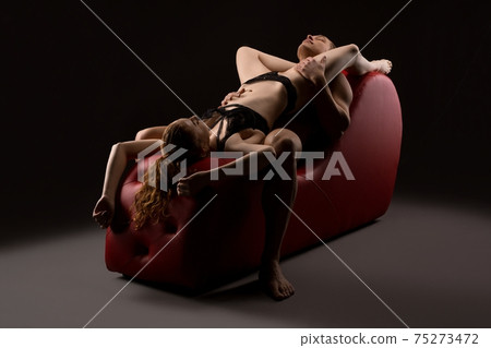 Passionate couple dream about sex on red leather chair Passionate couple dream about sex on red leather chair 75273472