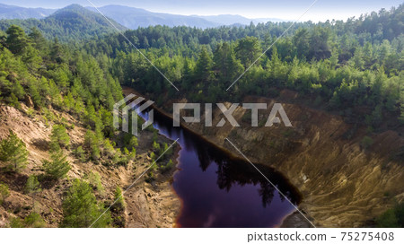 Toxic red lake in open pit of abandoned pyrite mine, aerial view landscape Toxic red lake in open pit of abandoned pyrite mine, aerial view landscape 75275408