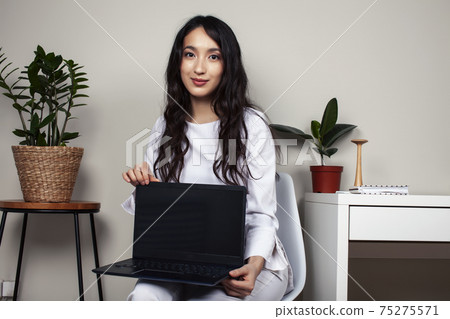 young pretty asian woman in white form working in clinic with laptop, lifestyle working people concept young pretty asian woman in white form working in clinic with laptop, lifestyle working people concept 75275571