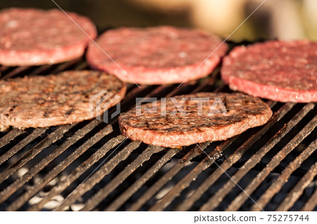 Hamburgers cooking on grill Hamburgers cooking on grill 75275744