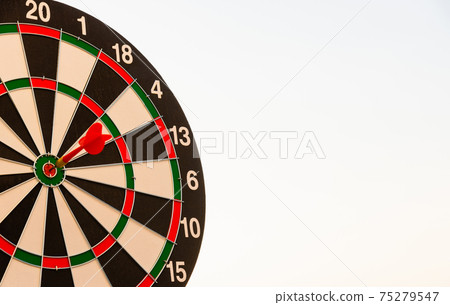 Dart arrow hit to center on bullseye of a dartboard 75279547