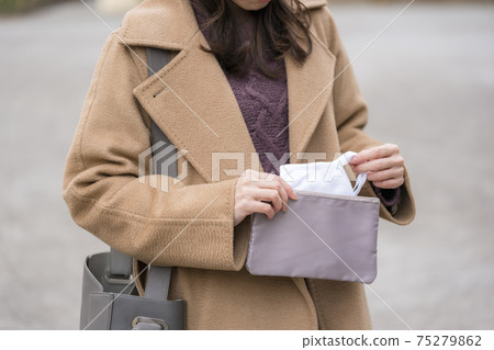 女人從口罩袋中取出口罩 75279862