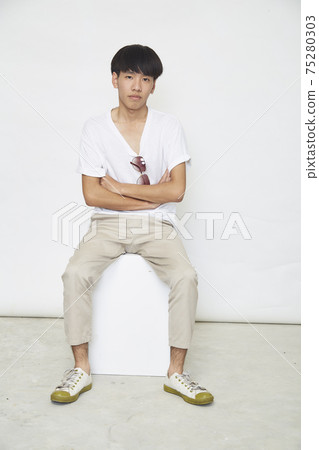 Handsome Asian guy on white 75280303