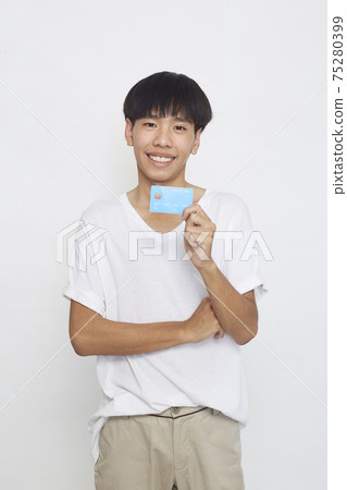 Asian man showing credit card Asian man showing credit card 75280399