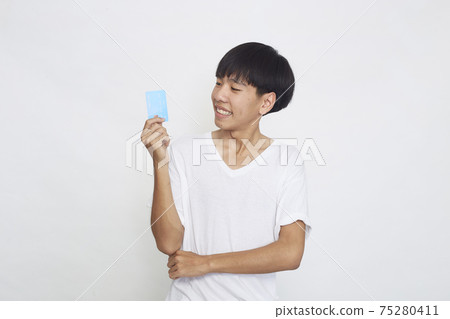 Asian man showing credit card Asian man showing credit card 75280411