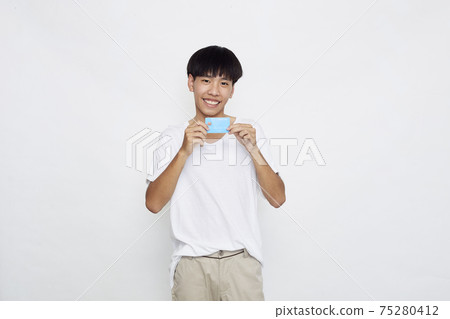 Asian man showing credit card Asian man showing credit card 75280412