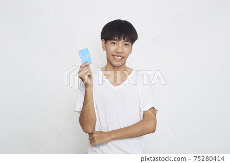 Asian man showing credit card Asian man showing credit card 75280414