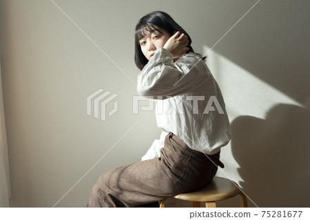 A woman relaxing in the room 75281677