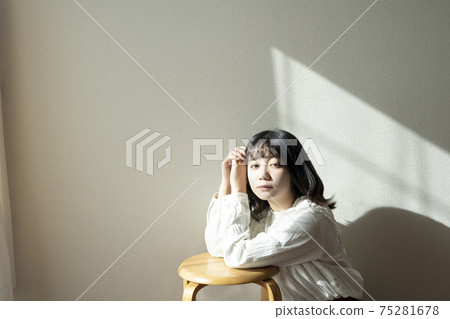 A woman relaxing in the room A woman relaxing in the room 75281678