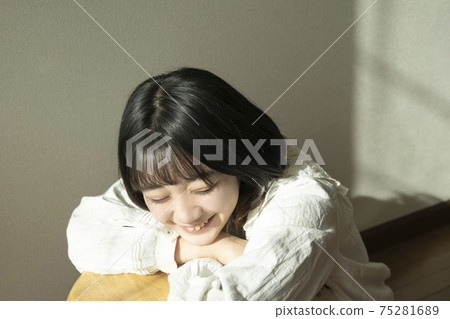 A woman relaxing in the room 75281689