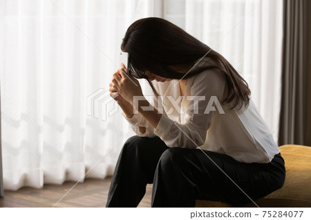 A woman holding a head A woman holding a head 75284077