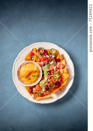 Nachos with ground beef, guacamole and cheese dip Nachos with ground beef, guacamole and cheese dip 75284923