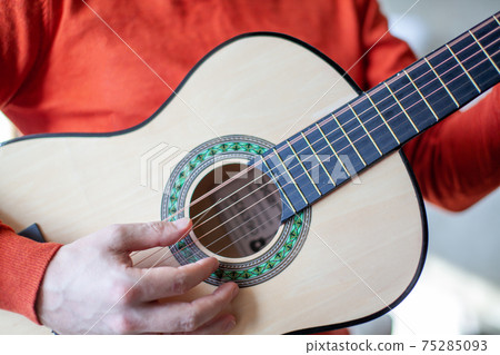 Close-up of a guitar player or a person learning to play the guitar. 75285093