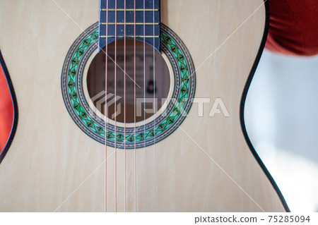Close-up of a guitar player or a person learning to play the guitar. Close-up of a guitar player or a person learning to play the guitar. 75285094