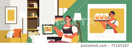 Oktoberfest party celebration woman with beer mugs discussing with girl in traditional clothes during video call 75285267