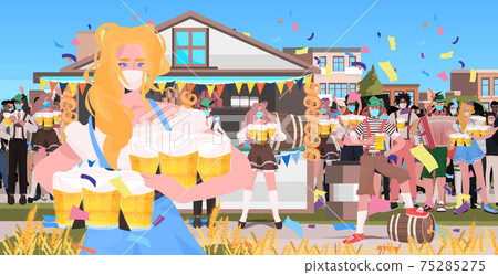 waitress in mask serving beer for mix race people octoberfest party celebration open air outdoor festival 75285275