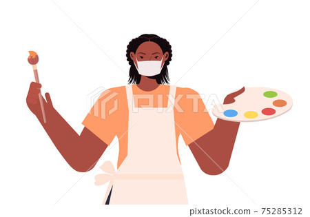 female painter holding paintbrush and palette labor day concept girl artist wearing mask to prevent coronavirus 75285312