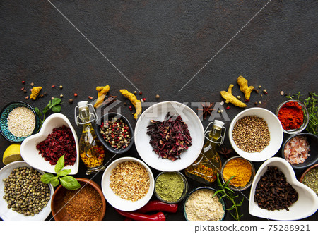 Various spices in a bowls on a black Various spices in a bowls on a black 75288921