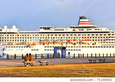 A luxury liner and a couple anchored at the large pier seen from the Red Brick Park 75289081