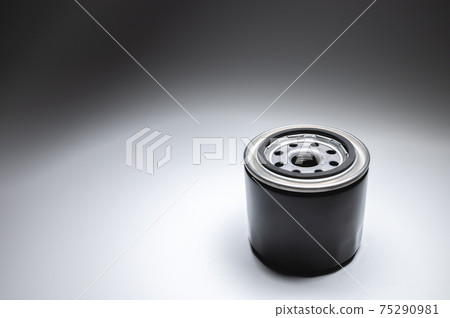 New oil filter in a black housing on a gradient gray background. New spare parts 75290981