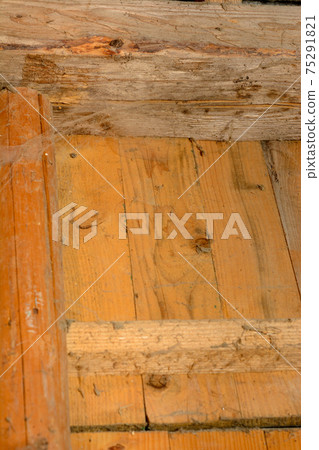 Many spider webs splashed on the wall with spider supports, the wall made of wooden horizontal boards. 75291821