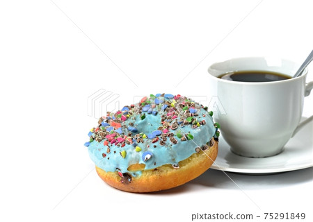 View of a sweet donut with blue icing and crushed candies. View of a sweet donut with blue icing and crushed candies. 75291849