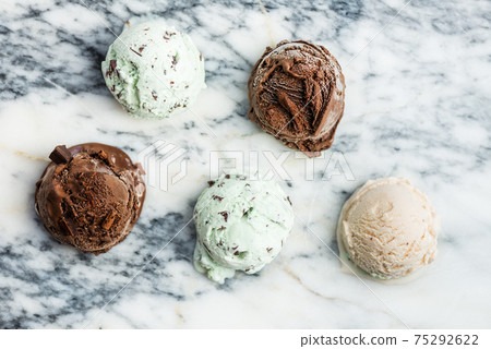 Selection of different ice cream scoops such as mint, chocolate and strawberry Selection of different ice cream scoops such as mint, chocolate and strawberry 75292622