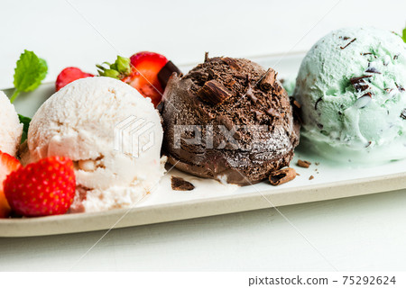 Selection of different ice cream scoops such as mint, chocolate and strawberry 75292624