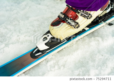 Close up of ski skier skier skier on snow white-violet color Close up of ski skier skier skier on snow white-violet color 75294711