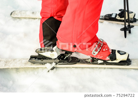 Close-up of a skier ski skier ski boot on a snow-red color Close-up of a skier ski skier ski boot on a snow-red color 75294722