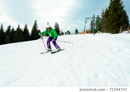The young guy skis in the Carpathians is not very skillful. The young guy skis in the Carpathians is not very skillful. 75294747